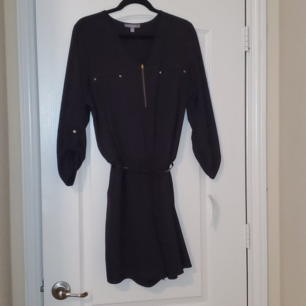 Black romper with gold zipper.